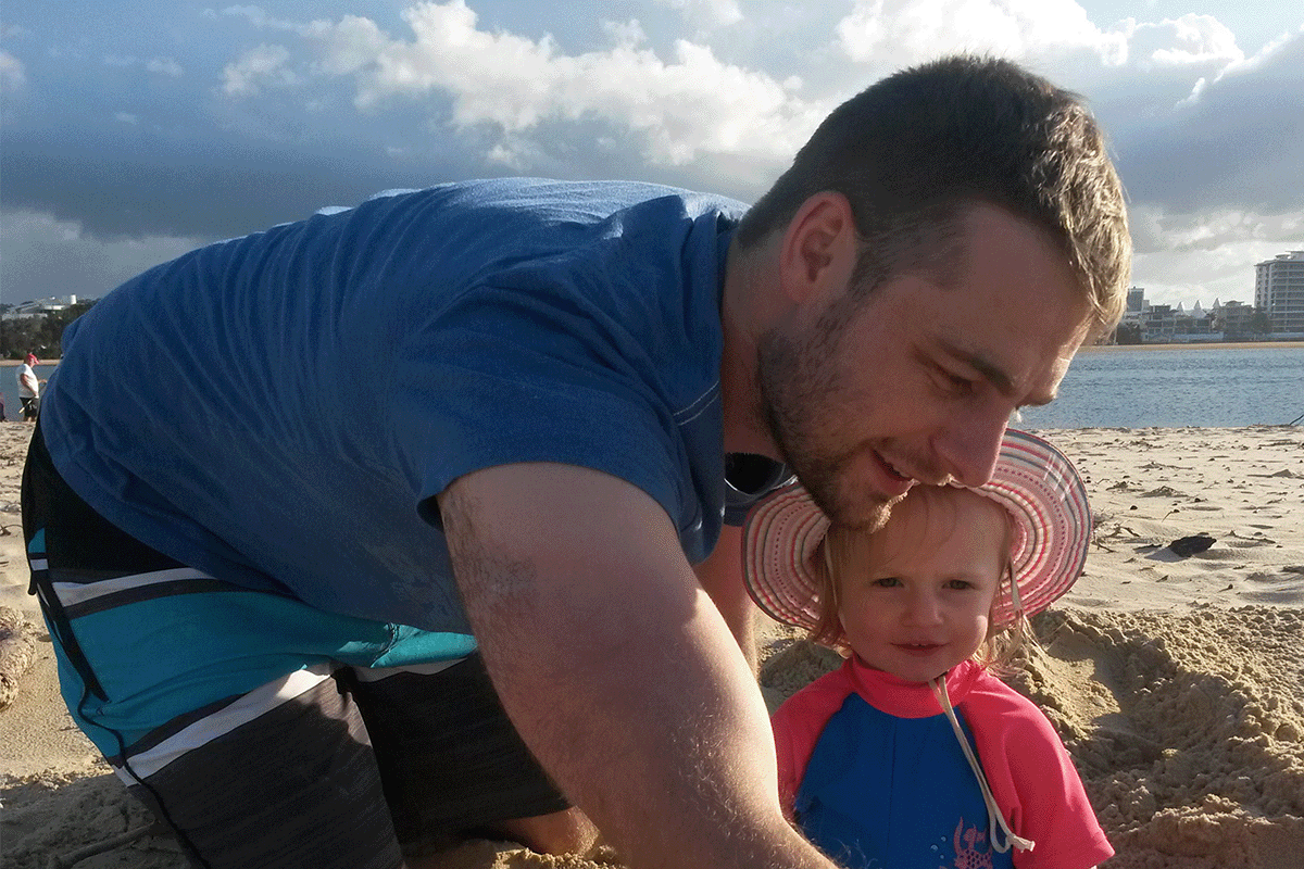 father and daughter on beach worldschooling